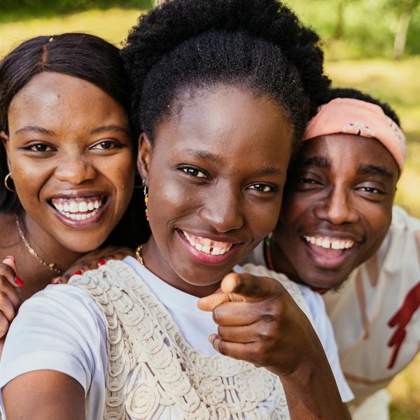Diverse group of people smiling during a light yoga session.