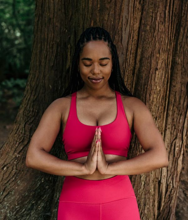Woman in a calm yoga pose, embodying mindful presence.